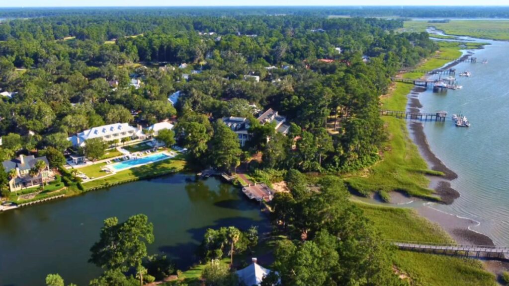 Aerial view of a waterfront residential area with lush greenery and water features in Bluffton, SC.